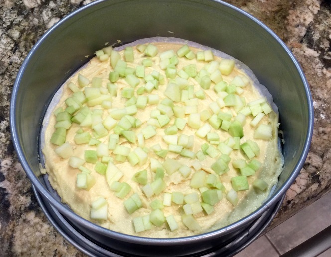 The first layer with the batter and diced apples