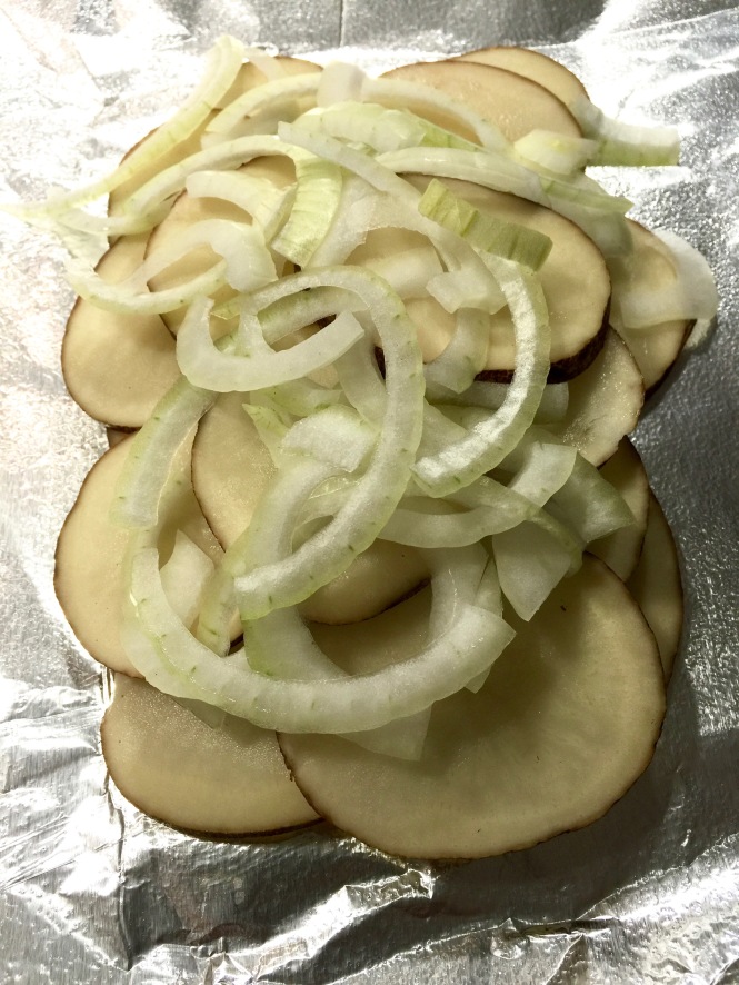 Place the potatoes and onion on a piece of foil sprayed with olive oil cooking spray